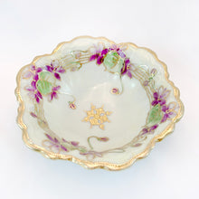 Load image into Gallery viewer, Stunning vintage hand painted Nippon porcelain bowl features purple violets, green leaves with gold moriage details resembling a musical staff. Crafted by Morimura Bros, Nippon, Japan, 1920s. A lovely piece to use as decor, trinket or candy dish.
In excellent condition, no chips.
Measures 5 1/2 x 2 1/2 inches