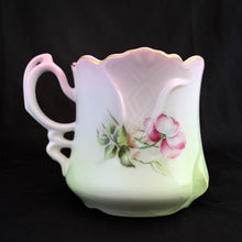 Load image into Gallery viewer, This vintage white porcelain shaving mug is hand painted with lovely pink and green florals with gold rim. Use as intended or repurpose as a toothbrush or make-up brush holder. Marked "Hand Painted Nippon". In excellent condition, no chips/cracks/repairs. Dimensions: 4-3/4" x 3-3/4"