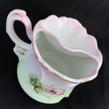 Load image into Gallery viewer, This vintage white porcelain shaving mug is hand painted with lovely pink and green florals with gold rim. Use as intended or repurpose as a toothbrush or make-up brush holder. Marked "Hand Painted Nippon". In excellent condition, no chips/cracks/repairs. Dimensions: 4-3/4" x 3-3/4"