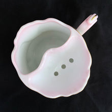 Load image into Gallery viewer, This vintage white porcelain shaving mug is hand painted with lovely pink and green florals with gold rim. Use as intended or repurpose as a toothbrush or make-up brush holder. Marked "Hand Painted Nippon". In excellent condition, no chips/cracks/repairs. Dimensions: 4-3/4" x 3-3/4"