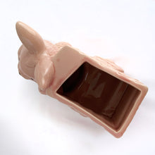 Load image into Gallery viewer, Adorable vintage pink ceramic planter of a bunny rabbit pulling a wagon. Made in Taiwan, circa 1960. Fill this pretty planter with your favourite houseplant or succulents. Could be filled with some delicious confections for a lovely Easter gift or display! In excellent condition, free from chips/cracks/repairs. 6 1/2 x 3 1/2 x 5 inches