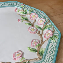 Load image into Gallery viewer, Beautiful vintage decorative plate in an octagon shape decorated pretty pink cherry blossom branches in relief, surrounded by an aqua coloured border with greek key design. Produced by Fitz & Floyd Essentials, circa 1990s. This piece has two holes on the back for ease of hanging. What a great piece of wall decor! In excellent condition, free from chips/cracks/repairs. Measures approximately 11 inches in diameter.