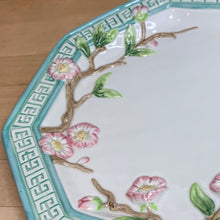 Load image into Gallery viewer, Beautiful vintage decorative plate in an octagon shape decorated pretty pink cherry blossom branches in relief, surrounded by an aqua coloured border with greek key design. Produced by Fitz & Floyd Essentials, circa 1990s. This piece has two holes on the back for ease of hanging. What a great piece of wall decor! In excellent condition, free from chips/cracks/repairs. Measures approximately 11 inches in diameter.