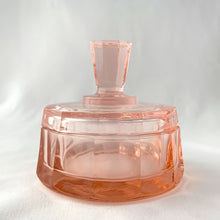 Load image into Gallery viewer, Stunning vintage twelve sided pink depression glass lidded vanity or trinket box with paneled finial. Circa 1930s.
In excellent vintage condition with one minor flea nic on the rim.
Measures 3 3/4 x 3 1/2 inches