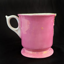 Load image into Gallery viewer, Vintage wood handled shaving brush and white porcelain shaving mug with raised slip details painted in pink, yellow and blue, highlighted in gold. Use as intended or repurpose as a toothbrush or make-up brush holder. Impressed mark "510" and painted "13". In good vintage condition, no cracks/repairs. The edge on the soap side is worn. Dimensions: 3-1/8" x 3"