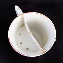 Load image into Gallery viewer, Vintage wood handled shaving brush and white porcelain shaving mug with raised slip details painted in pink, yellow and blue, highlighted in gold. Use as intended or repurpose as a toothbrush or make-up brush holder. Impressed mark "510" and painted "13". In good vintage condition, no cracks/repairs. The edge on the soap side is worn. Dimensions: 3-1/8" x 3"
