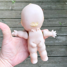 Load image into Gallery viewer, Rare porcelain bisque Kewpie Doll figurine with moveable string jointed arms. It's difficult to find this specific one standing with its legs apart which is what makes this one rare. Excellent vintage condition, free from chips or cracks. String could be tightened. This delightful little cutie stands at approximately 7" inches tall and comes with a metal stand.