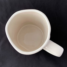 Load image into Gallery viewer, "MRS." off white ceramic mug. Marked on the bottom, Rae Dunn Artisan Collection by Magenta 202. Rae Dunn's designs are instantly recognizable....they are mostly cream-colored tableware, typically emblazoned with one- or two-word phrases using a simple hand-written style font. In excellent condition free from chips/cracks/repairs. Measures 5 x 4 1/2 inches (includes handle) Capacity 16 ounces