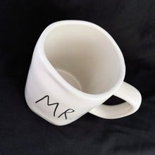 Load image into Gallery viewer, "MR." off white ceramic mug. Marked on the bottom, Rae Dunn Artisan Collection by Magenta 202. Rae Dunn's designs are instantly recognizable....they are mostly cream-colored tableware, typically emblazoned with one- or two-word phrases using a simple hand-written style font. In excellent condition free from chips/cracks/repairs. Measures 5 x 4 1/2 inches (includes handle) Capacity 16 ounces