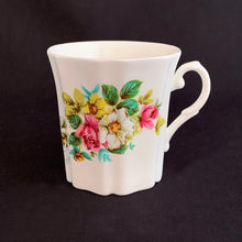 Load image into Gallery viewer, Treat yourself to a cuppa in this lovely feminine shaped fine bone china mug featuring beautiful bouquet of white, yellow and pink roses with green leaves on white bone china. Crafted by Royal Grafton, England, circa 1970s. Grafton made these mugs with many floral designs — collect them all! In excellent condition, no chips, cracks or crazing. Marked on the bottom with "Royal Grafton, Fine Bone China, Made in England". Measures 3 1/4 x 3 1/4 inches