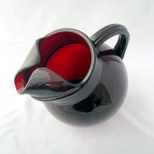 Load image into Gallery viewer, A super cool vintage Royal Ruby Roly Poly ice lip glass pitcher with ribbed collar and handle. Crafted by Anchor Hocking, USA, 1950s. A great addition to your barware collection and perfect for the holiday season!
In good vintage condition, no chips, minor wear in one spot.
Measures 7 x 5 x 6 1/2 inches
Capacity 32 ounces