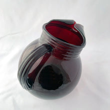 Load image into Gallery viewer, A super cool vintage Royal Ruby Roly Poly ice lip glass pitcher with ribbed collar and handle. Crafted by Anchor Hocking, USA, 1950s. A great addition to your barware collection and perfect for the holiday season!
In good vintage condition, no chips, minor wear in one spot.
Measures 7 x 5 x 6 1/2 inches
Capacity 32 ounces
