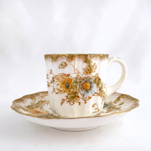 Load image into Gallery viewer, Antique Victorian style "Rutland" demitasse cup and saucer, with blue and yellow flowers trimmed in gold gilt. Crafted by Doulton Burslem, Staffordshire England, circa 1891 - 1902. An absolutely stunning addition to your teacup collection! In excellent condition, free from chips/cracks/repairs. Makers marks present. Cup measures 2 1/8 x 2 1/8 inches and saucer is approximately 4 inches