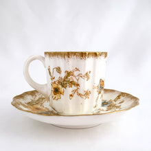 Load image into Gallery viewer, Antique Victorian style "Rutland" demitasse cup and saucer, with blue and yellow flowers trimmed in gold gilt. Crafted by Doulton Burslem, Staffordshire England, circa 1891 - 1902. An absolutely stunning addition to your teacup collection! In excellent condition, free from chips/cracks/repairs. Makers marks present. Cup measures 2 1/8 x 2 1/8 inches and saucer is approximately 4 inches