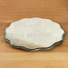 Load image into Gallery viewer, Beautiful vintage Victorian scalloped and beaded edge mirror or vanity stand. This metal backed mirror may be used on a flat surface or hung on a wall. It's a lovely piece that would add some romance to any space. In good used vintage condition, minor marks to the mirror surface. Measures 12 x 1/2 inches