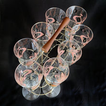 Load image into Gallery viewer, Make any day a special occasion with these highly collectible and hard to find vintage mid-century atomic style Seville pilsner or champagne glasses. Decorated with a graphic geometric design in swirls of pink, charcoal black and gold, they remind us of a New Year's eve party and are perfect for that midnight champagne toast! Bonus, they come in the original wood handled brass caddy.