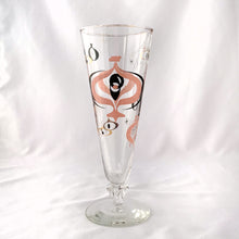 Load image into Gallery viewer, Make any day a special occasion with these highly collectible and hard to find vintage mid-century atomic style Seville pilsner or champagne glasses. Decorated with a graphic geometric design in swirls of pink, charcoal black and gold, they remind us of a New Year's eve party and are perfect for that midnight champagne toast! Bonus, they come in the original wood handled brass caddy.
