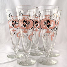 Load image into Gallery viewer, Make any day a special occasion with these highly collectible and hard to find vintage mid-century atomic style Seville pilsner or champagne glasses. Decorated with a graphic geometric design in swirls of pink, charcoal black and gold, they remind us of a New Year's eve party and are perfect for that midnight champagne toast! Bonus, they come in the original wood handled brass caddy.