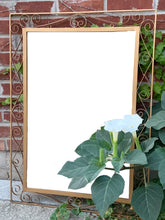 Load image into Gallery viewer, A vintage mirror featuring a fabulous wrought iron scroll design, painted gold and backed in wood. All ready to hang! In great vintage condition