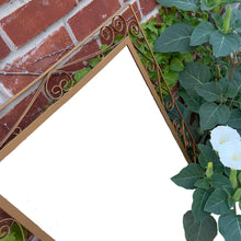 Load image into Gallery viewer, A vintage mirror featuring a fabulous wrought iron scroll design, painted gold and backed in wood. All ready to hang! In great vintage condition