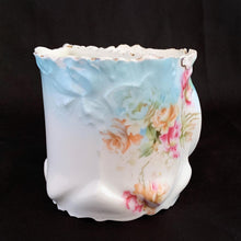 Load image into Gallery viewer, This vintage white porcelain shaving mug begs the question, "who is the fairest of them all" with it's unique round mirror edged in enamel or copper. The mug is hand painted with lovely pink and yellow roses and decorative edge with gold. Use as intended or repurpose as a toothbrush or make-up brush holder. Stamped with maker's mark, "Royal Coburg, Germany". In used vintage condition, minor chips at the edge no cracks/repairs. Measures 3 1/8 x 3 inches