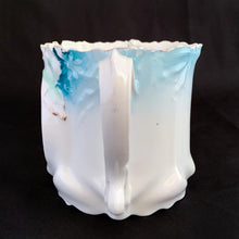 Load image into Gallery viewer, This vintage white porcelain shaving mug begs the question, "who is the fairest of them all" with it's unique round mirror edged in enamel or copper. The mug is hand painted with lovely pink and yellow roses and decorative edge with gold. Use as intended or repurpose as a toothbrush or make-up brush holder. Stamped with maker's mark, "Royal Coburg, Germany". In used vintage condition, minor chips at the edge no cracks/repairs. Measures 3 1/8 x 3 inches