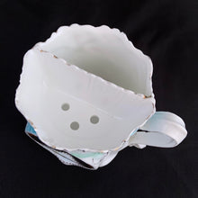 Load image into Gallery viewer, This vintage white porcelain shaving mug begs the question, "who is the fairest of them all" with it's unique round mirror edged in enamel or copper. The mug is hand painted with lovely pink and yellow roses and decorative edge with gold. Use as intended or repurpose as a toothbrush or make-up brush holder. Stamped with maker's mark, "Royal Coburg, Germany". In used vintage condition, minor chips at the edge no cracks/repairs. Measures 3 1/8 x 3 inches