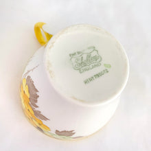 Load image into Gallery viewer, Lovely vintage Phlox Yellow Trim teacup, saucer and salad plate trio. Produced by Shelley, England. Circa 1940. In excellent vintage condition, free from chips/cracks. Minor manufacturer's defect on rim of salad plate and underside has slight discoloration (see photos). Cup measures 3-1/4" x 2-5/8" with registration mark "795072" and a green infinity sign. Saucer measures 5-3/8" marked "071 D" Plate measures 6-7/8" "IDEAL CHINA No. C.R.071" yellow "C" 2 dots