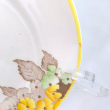 Load image into Gallery viewer, Lovely vintage Phlox Yellow Trim teacup, saucer and salad plate trio. Produced by Shelley, England. Circa 1940. In excellent vintage condition, free from chips/cracks. Minor manufacturer's defect on rim of salad plate and underside has slight discoloration (see photos). Cup measures 3-1/4" x 2-5/8" with registration mark "795072" and a green infinity sign. Saucer measures 5-3/8" marked "071 D" Plate measures 6-7/8" "IDEAL CHINA No. C.R.071" yellow "C" 2 dots