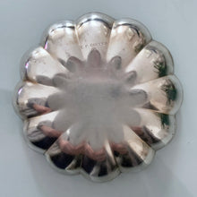 Load image into Gallery viewer, Sweet vintage silver plate scalloped shaped dish beautifully engraved with a pattern of shells and hearts. Marked EP Copper along with a shield with an "R" for Roden Bros. Ltd. The perfect piece to brighten up a vanity table to hold trinkets, in a powder room to display fancy soaps or in an entryway filled with treats. In good vintage condition. Measures 4" x 1/2"