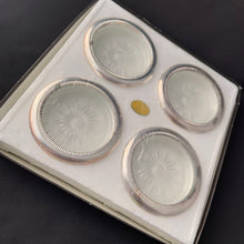Load image into Gallery viewer, Vintage set of 4 silver plate rimmed crystal coasters featuring a cut sunburst and finished in a silver plate rolled rim with beaded detail. Perfect to protect your furniture from water marks. A super sparkly and elegant resting place for your beverage!
In excellent condition. In original box. Crafted by Leonard in Italy.
Each coaster measures 4 x 3/4 inches