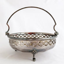 Load image into Gallery viewer, Beautiful vintage EPNS silver plated basket with pierced detail band on a rosette bottomed bowl with three feet and handle. Produced by JT & Co., Sheffield England. In good vintage as found condition. Marked on the bottom "MADE IN ENGLAND, JT&CO. EPNS 2017. Measures 5-7/8" x 2-1/4" (5-1/2" w/ handle upright)