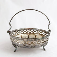 Load image into Gallery viewer, Beautiful vintage EPNS silver plated basket with pierced detail band on a rosette bottomed bowl with three feet and handle. Produced by JT & Co., Sheffield England. In good vintage as found condition. Marked on the bottom "MADE IN ENGLAND, JT&CO. EPNS 2017. Measures 5-7/8" x 2-1/4" (5-1/2" w/ handle upright)