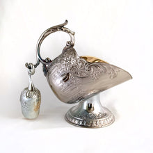Load image into Gallery viewer, This vintage silver plated sugar scuttle and scoop set, embossed with roses, flowers, leaves and scroll details No 540. It's just a beautiful vessel for sugar cubes or bath salts. Produced by Leonard Manufacturing Ltd. in Japan. In good vintage condition. In original box. Measures approx. 6-1/4" x 3.5" x 6"