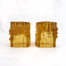 Load image into Gallery viewer, Stunning pair of vintage mid-century brutalist style amber candle holders. Versatile, may be used with tapers or votive candles. Designed by artisan Vladislav Urban for Sklo Union, Rosice Glassworks, Czechoslovakia, circa 1968. A gorgeous way to add glow to your life!
In excellent condition, free from chips/cracks.
Measures 2 3/8 x 2 3/8 x 3 1/8 inches