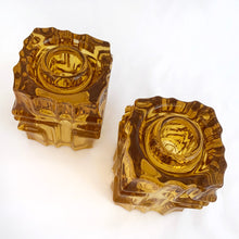 Load image into Gallery viewer, Stunning pair of vintage mid-century brutalist style amber candle holders. Versatile, may be used with tapers or votive candles. Designed by artisan Vladislav Urban for Sklo Union, Rosice Glassworks, Czechoslovakia, circa 1968. A gorgeous way to add glow to your life!
In excellent condition, free from chips/cracks.
Measures 2 3/8 x 2 3/8 x 3 1/8 inches