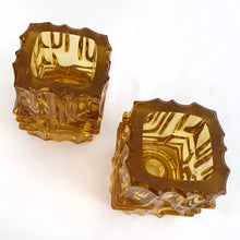 Load image into Gallery viewer, Stunning pair of vintage mid-century brutalist style amber candle holders. Versatile, may be used with tapers or votive candles. Designed by artisan Vladislav Urban for Sklo Union, Rosice Glassworks, Czechoslovakia, circa 1968. A gorgeous way to add glow to your life!
In excellent condition, free from chips/cracks.
Measures 2 3/8 x 2 3/8 x 3 1/8 inches