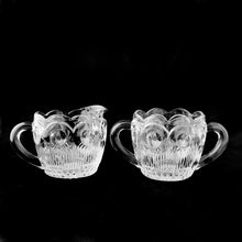 Load image into Gallery viewer, Known as the "crystal of the southwest", this "St. Genevieve" clear pressed glass creamer and sugar are beautifully designed with arches, dots and cut vertical ribs with a scalloped edge and multiple hexagon design on the bottoms. Produced by the Bartlett-Collins Glass Company between 1950-1970. In excellent condition, free from chips/cracks. Measures approximately 3 inches
