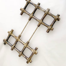 Load image into Gallery viewer, This beautiful vintage Hollywood Regency silver plated bamboo tiki style trivet conveniently extends to accommodate larger dishes and its rubber feet will protect surfaces. Sticker on the bottom reads "Silver Plated Zinc". Crafted in Hong Kong, circa 1950s. A great way to protect your furniture from getting marked by hot ovenware! Measures 7 1/4 x 7 1/4 and extends to 10 1/4 inches