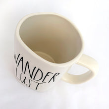 Load image into Gallery viewer, An authentic Rae Dunn Artisan Collection mug with the word "WANDERLUST" in their distinct font. Produced by Magenta. Perfect for your morning, noon or nighttime cuppa joe! In mint condition. Measures 5 x 4 1/2 (includes handle) Capacity 16oz