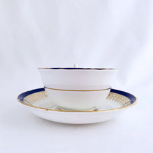 Load image into Gallery viewer, This vintage bone china teacup and saucer is absolutely stunning! Both the cup and saucer are glazed in white with a blue band, gold geometric pattern and rim with a central bouquet of colourful flowers. Produced by Royal Grafton, England, circa 1950 - 1956. In excellent condition, free from chips, cracks and repairs. Pattern number 1781 marked on the bottom of the teacup. Teacup measures 3-7/8" x 2" | Saucer measures 5-5/8"