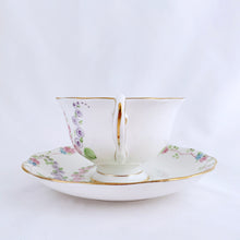 Load image into Gallery viewer, This antique bone china footed teacup and saucer is so sweet! Both the cup and saucer have a lovely scalloped edge with hand painted whimsical pastel coloured foxglove flowers and rimmed with gold gilt. Produced by Royal Albert, England, circa 1917 - 1927. In good condition. Teacup measures 3 3/4 x 2 3/8 inches | Saucer measures 5 1/2 inches