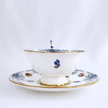 Load image into Gallery viewer, Antique bone china teacup and saucer with scalloped edge and decorated with hand painted pansies and roses with a blue graphic plant and rimmed with gold gilt. Produced by Coalport, England, circa 1900. In good condition, free from chips, cracks and repairs. Manufacturer's defect to the right of the handle at the rim. Pattern number 8252 and maker's marks are on the bottom of the teacup and maker's mark on the saucer. Teacup measures 4" x 2-1/8" | Saucer measures 5-3/4"