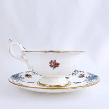 Load image into Gallery viewer, Antique bone china teacup and saucer with scalloped edge and decorated with hand painted pansies and roses with a blue graphic plant and rimmed with gold gilt. Produced by Coalport, England, circa 1900. In good condition, free from chips, cracks and repairs. Manufacturer's defect to the right of the handle at the rim. Pattern number 8252 and maker's marks are on the bottom of the teacup and maker's mark on the saucer. Teacup measures 4" x 2-1/8" | Saucer measures 5-3/4"