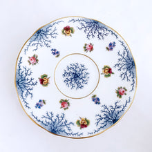 Load image into Gallery viewer, Antique bone china teacup and saucer with scalloped edge and decorated with hand painted pansies and roses with a blue graphic plant and rimmed with gold gilt. Produced by Coalport, England, circa 1900. In good condition, free from chips, cracks and repairs. Manufacturer's defect to the right of the handle at the rim. Pattern number 8252 and maker's marks are on the bottom of the teacup and maker's mark on the saucer. Teacup measures 4" x 2-1/8" | Saucer measures 5-3/4"