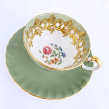 Load image into Gallery viewer, vintage bone china teacup and saucer with a lovely scalloped shape. The cup is a lovely shade of celadon green, interior celadon band is overlaid with a complex gold pattern with a central bouquet of colourful flowers. Saucer is celadon green with a white centre and gold gilt rim. Produced by Aynsley, England, circa 1939. In excellent condition, free from chips, cracks and repairs. Pattern number C1557 with maker's marks. Teacup measures 3-1/2" x 2-1/4" | Saucer measures 5-5/8"