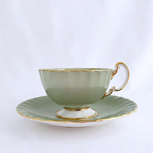 Load image into Gallery viewer, vintage bone china teacup and saucer with a lovely scalloped shape. The cup is a lovely shade of celadon green, interior celadon band is overlaid with a complex gold pattern with a central bouquet of colourful flowers. Saucer is celadon green with a white centre and gold gilt rim. Produced by Aynsley, England, circa 1939. In excellent condition, free from chips, cracks and repairs. Pattern number C1557 with maker's marks. Teacup measures 3-1/2" x 2-1/4" | Saucer measures 5-5/8"