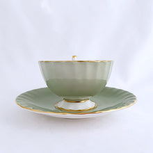 Load image into Gallery viewer, vintage bone china teacup and saucer with a lovely scalloped shape. The cup is a lovely shade of celadon green, interior celadon band is overlaid with a complex gold pattern with a central bouquet of colourful flowers. Saucer is celadon green with a white centre and gold gilt rim. Produced by Aynsley, England, circa 1939. In excellent condition, free from chips, cracks and repairs. Pattern number C1557 with maker's marks. Teacup measures 3-1/2" x 2-1/4" | Saucer measures 5-5/8"