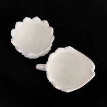 Load image into Gallery viewer, Vintage white milk glass is the epitome of simple elegance! This is a scalloped creamer and lidded sugar bowl in the "Hobnail" pattern. Produced by Fenton, post 1970. Marked. The creamer is in excellent condition, free from chips or cracks. The sugar bowl has a chip on the side of one of the scalloped points...it's not rough or really noticeable thanks to the piece being white. Creamer measures 4" 3-1/2", sugar w/ lid measures 4" x 4-3/4"