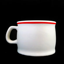 Load image into Gallery viewer, Vintage Designers Collection Ziggy comic stoneware mug. This heavy stoneware mug is white with a red stripe around the rim along with Ziggy and his colourful group of furry friends with the phrase "Soups On“ in a cartoon speech bubble. The perfect mug for your favourite cup of soup! Designed by cartoonist Tom Wilson for Universal Press Syndicate. Made in Korea, 1982. In excellent condition, free from chips/cracks/wear. Appears to not have been used. Measures 4 x 2-7/8 inches Capacity 12 ounces